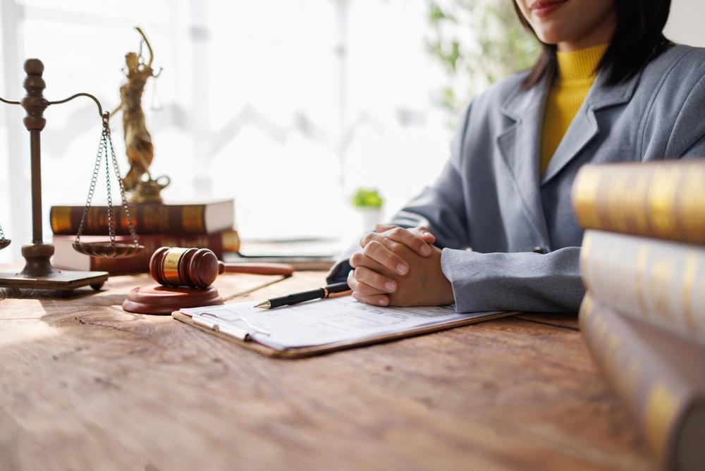 Lawyers Consultation and conference discussing legal matters at a desk with a gavel, scales of justice law symbolizing law and justice, justice and lawyer Business partnership meeting concept.