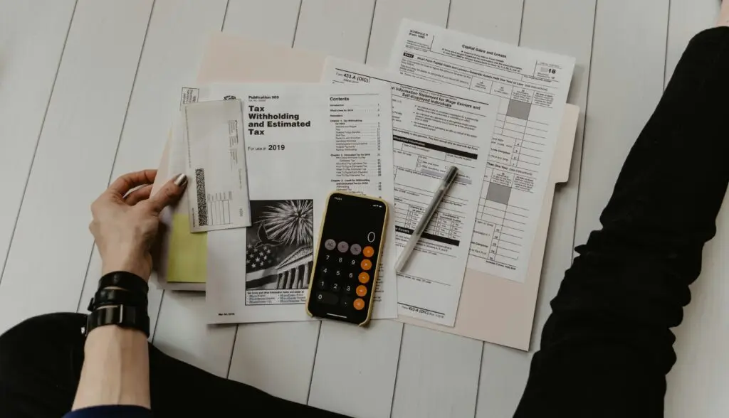Taxation paperwork in a table and calculator