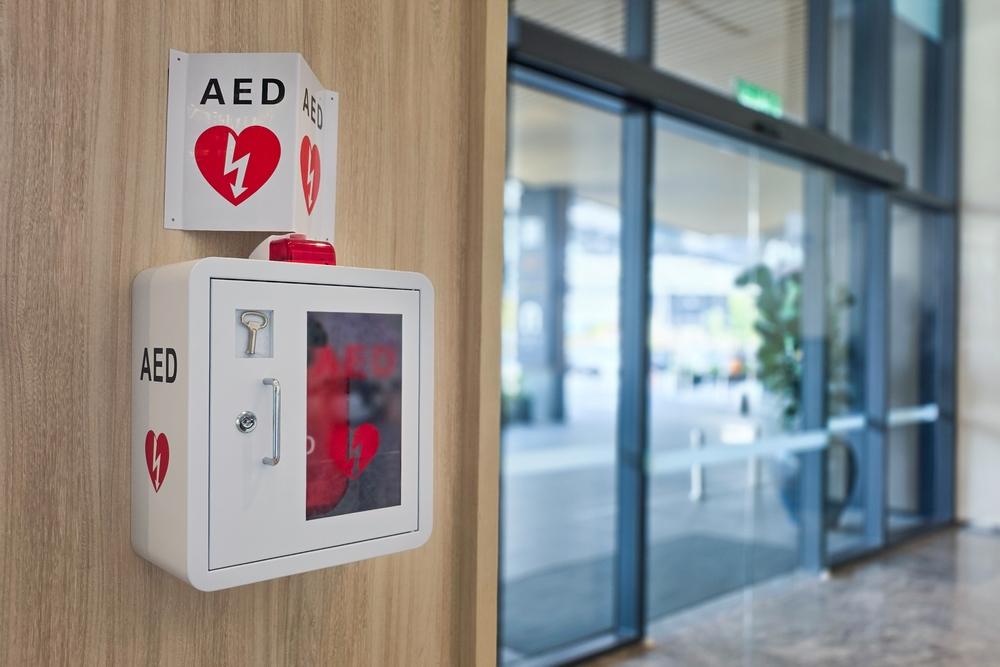 AED or Automated External Defibrillator installed on wall in hotel lobby as first aid in heart attack situation.