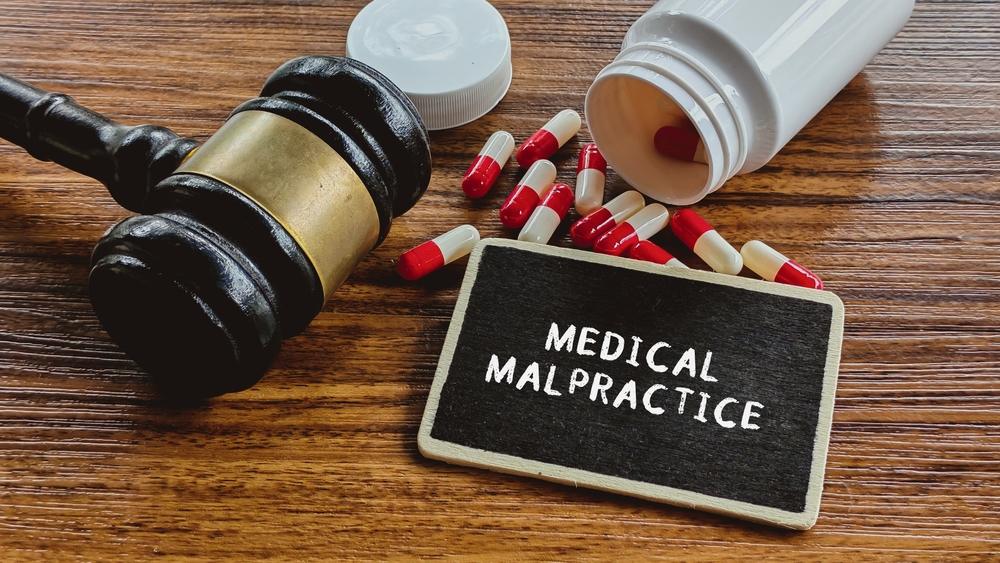 Medical Malpractice Legal Action Gavel, Pills, and Medicine Bottle Representing Healthcare Negligence Lawsuit